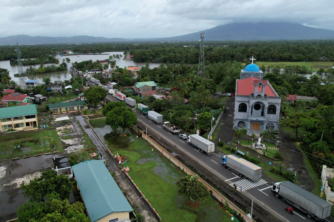 Trucks are stranded along a flooded highway in Nabua town, Camarines Sur province, south of Manila, Philippines, on October 23, 2024.