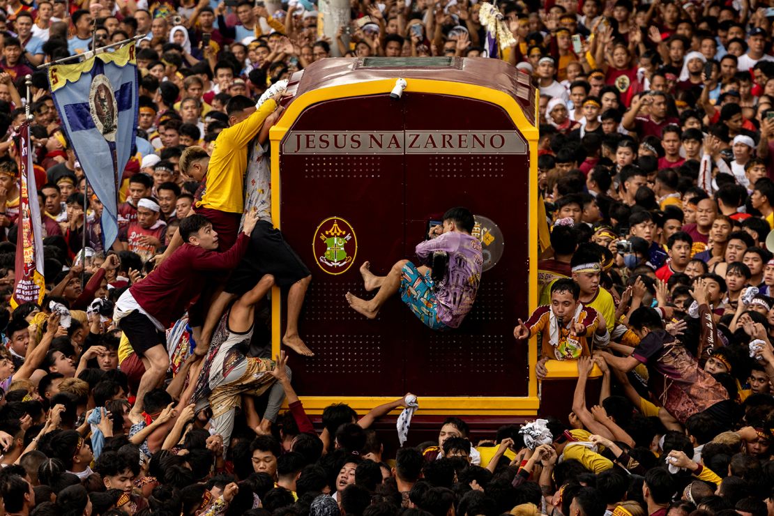 Filipino Catholic devotees jostle to touch the carriage carrying the statue of the Black Nazarene during the procession in Manila on Thursday.