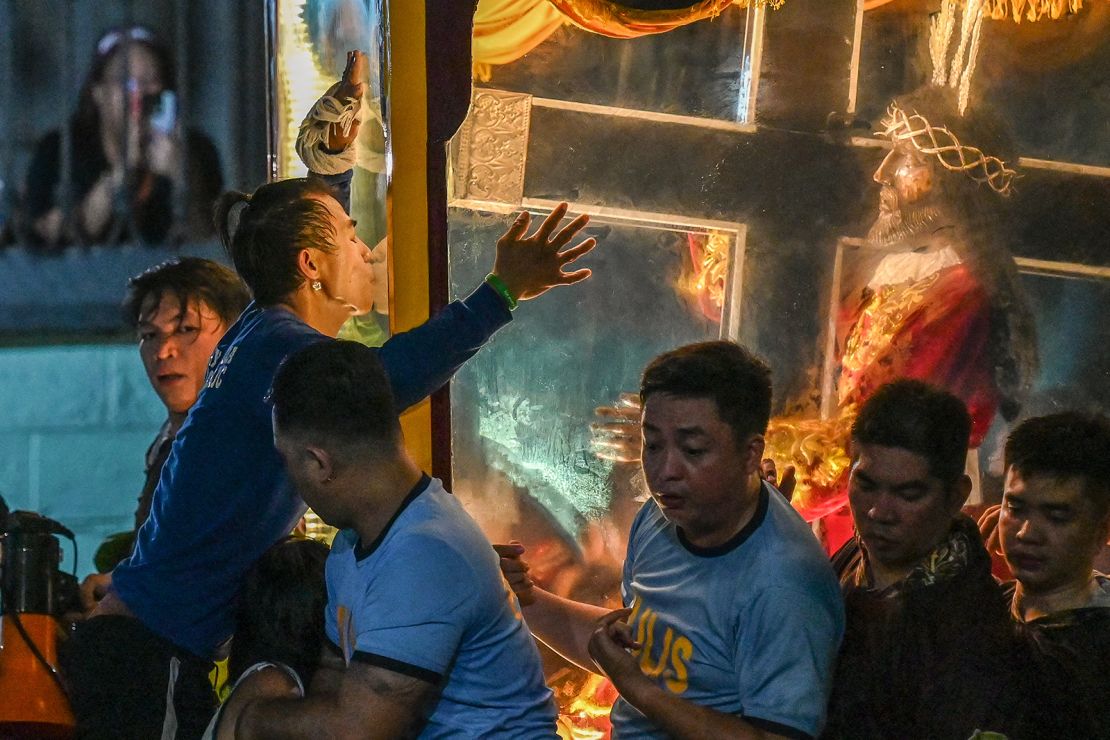 A Catholic devotee kisses the carriage during the procession in Manila.